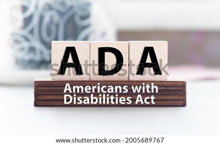 Word ADA Americans with Disabilities Act is made of wooden building blocks. Concept.