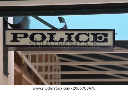 Police sign hanging on building