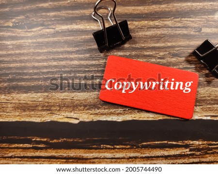 Business concept. Text Copywriting on color board with paper clips on wooden table background.