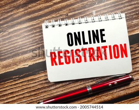 Business concept. Text ONLINE REGISTRATION on notebook with pen on wooden table background.
