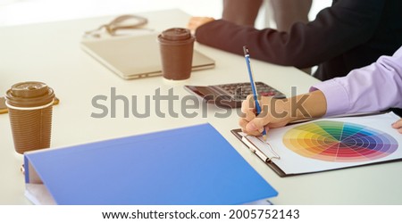 Scene of lecture in meeting with hand of businesswoman writing on paper chart in seminar business session