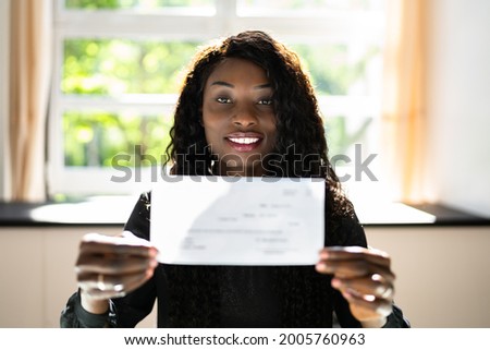 Black Business Woman Holding Pay Check Or Paycheck