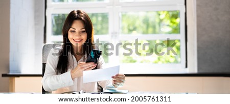 Remote Cheque Deposit Using Mobile Phone. Check Capture Royalty-Free Stock Photo #2005761311