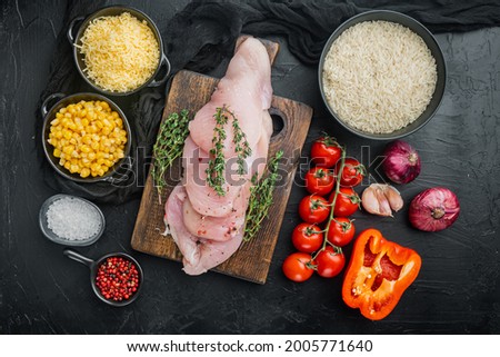 Mexican food ingredients Chicken Enchilada, Rice Casserole, on black background, top view flat lay