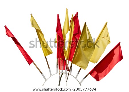 Texture of multi-colored festive red, yellow flags made of fabric. Holiday celebration satin flags of different colors in the wind. Isolate on a white background.