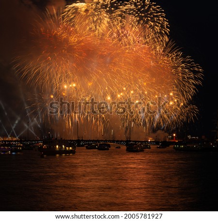 night city fireworks above river long exposure image