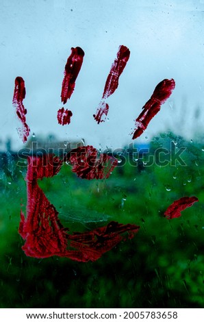hand print on glass with paint