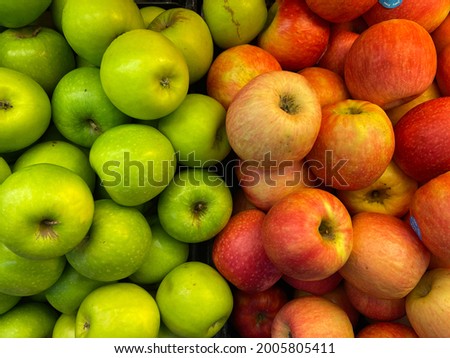 Green and red apples as background