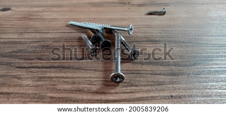 Wood screws on a wooden pattern background