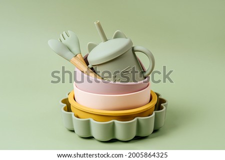 Set of children's bowls, plates and spoon. Baby tableware. Nutrition and feeding concept. Royalty-Free Stock Photo #2005864325