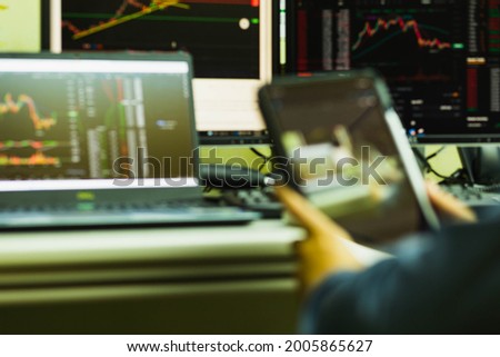 Blurred image of a man trading cryptocurrency through on  tablet
