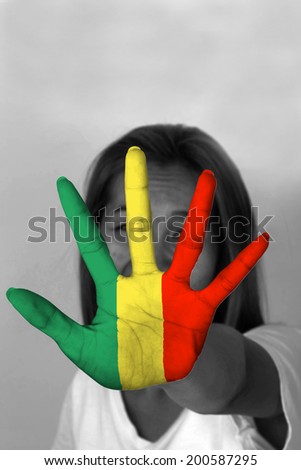 woman with her hands signaling to stop and Mali flag