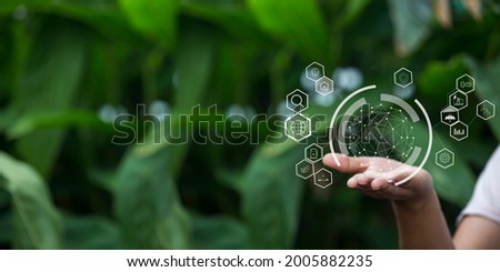 Technology, hand holding with environment Icons over the Network connection on green background. Royalty-Free Stock Photo #2005882235