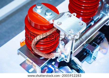 Red current transformers. Two current transformers close-up. Abstract equipment mechanism with a transformer. Fragment of electrical equipment. Close-up of a copper wire transformer. Royalty-Free Stock Photo #2005912283
