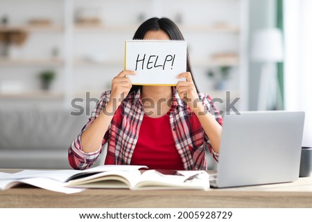 Stressed Unrecognizable Female Holding Leaflet With Drawn Help Word In Front Of Face While Study Online With Laptop At Home, Student Woman Suffering Problems With Remote Education, Closeup Royalty-Free Stock Photo #2005928729