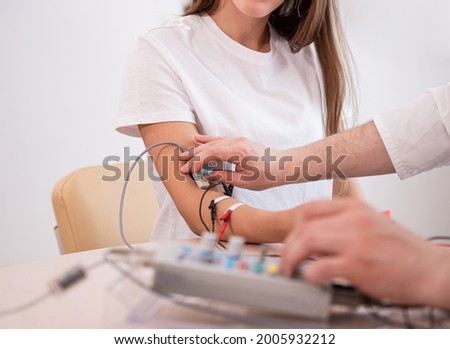 Patient nerves testing using electromyography at medical center Royalty-Free Stock Photo #2005932212