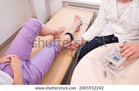 Patient nerves testing using electromyography at medical center Royalty-Free Stock Photo #2005932242