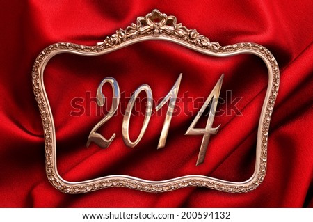 Gold 2014 in an antique frame, red silk background