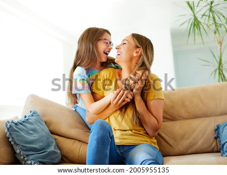 mother and daughter playing and having fun at home