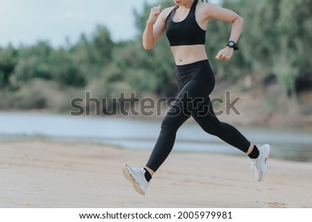 woman running by the river in the evening