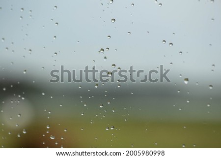 Raindrops on the glass at beautiful gentle nature gradient colors. Soft gradient background from light grey to dark grey and green.