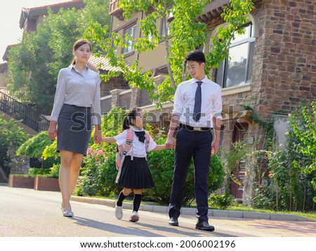 Young parents send their children to school high quality photo