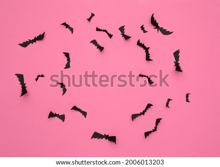 Flying bats on pink background. Halloween background. Top view. Flat lay