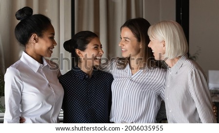 Group of interns and teacher celebrating success, training completion, hiring, career start, talking, hugging, laughing, having fun. Happy united female business team members, company staff portrait