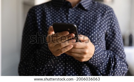Woman with cell making video phone call, using online app and virtual services, reading online article, shopping, chatting on social media. Hands of smartphone user holding digital device, close up