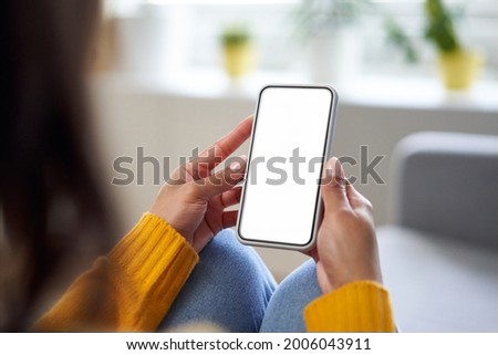 Smartphone mockup. Closeup of woman using mobile phone with empty screen at home