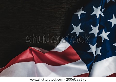 American flag on dark wooden background with place for text