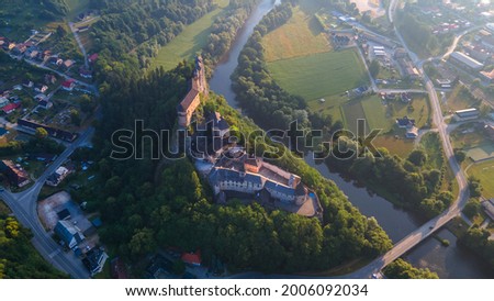 Panoramic aerial view of the beautiful  Orava Castle and its surroundings over Orava river, Slovakia, green summer scenery, blue sky, early morning, drone photography
