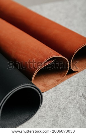 Roll of red leather on a black background