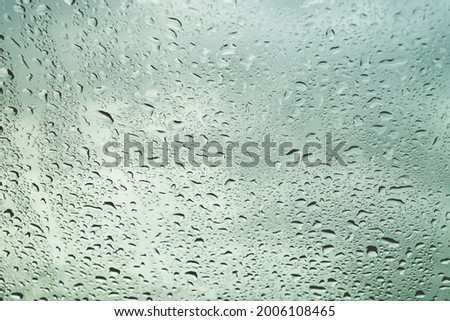 Rain drop on glass window in monsoon season for abstract and background concept.