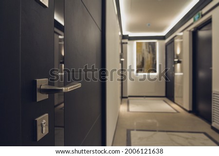 Hotel corridor with apartment. Closed doors in the hallway. Hospitality business