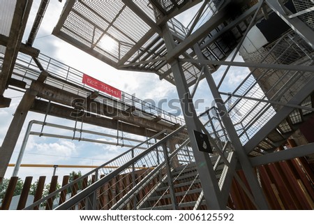 Scenic metal stairs construction with red sign plate with inscription "no silence"