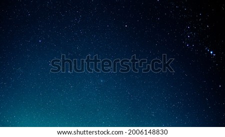 Photo of the night sky illuminated and littered with stars.