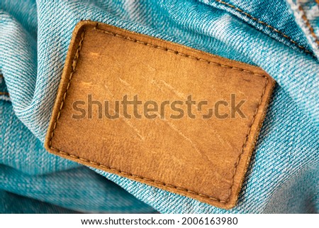 Leather tag on jeans background
