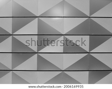 The decorative design triangle grey and white shapes pattern background with four horizontal lines