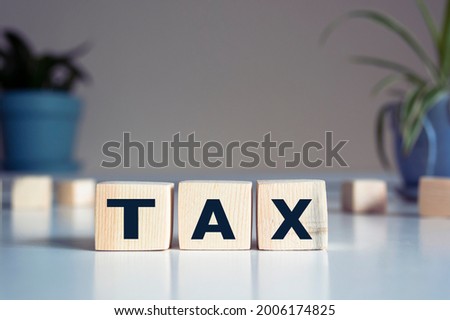 The inscription tax on wooden cubes on a blur background
