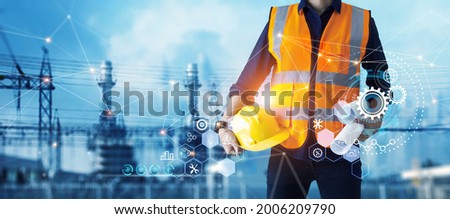Male industrial, Electrical engineer with helmet and blueprints in hands checking, maintenance, and analysis data of power plant station project on substation and network background. Royalty-Free Stock Photo #2006209790