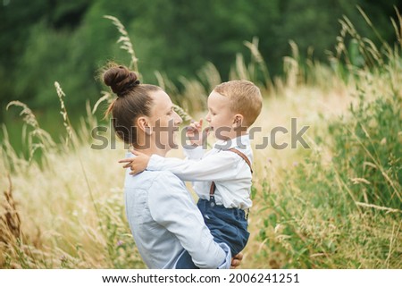 mother holds in her arms a smiling child, the concept of family life 