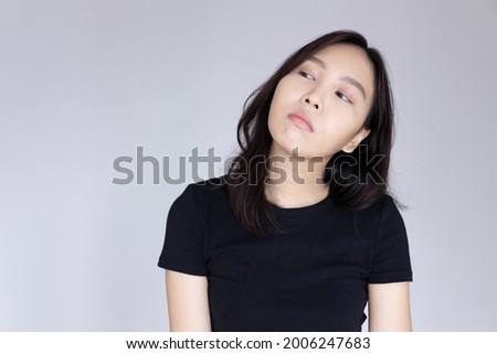unhappy woman looking up with rolling eyes expression Royalty-Free Stock Photo #2006247683