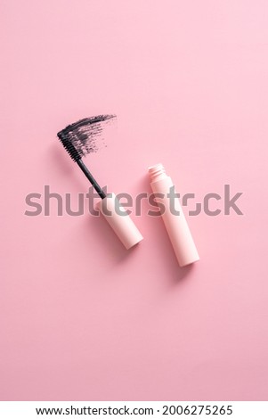 Flat lay mascara with stroke on pink background. Royalty-Free Stock Photo #2006275265