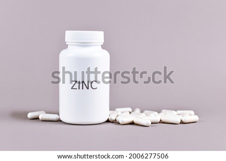 Bottle with Zinc mineral supplement inscription with capsules Royalty-Free Stock Photo #2006277506