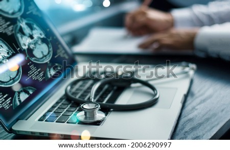 Medicine doctor research and analysis. Diagnose checking brain testing result patient with screen interface on laptop and stethoscope, Futuristic healthcare, Medical technology and innovative concept Royalty-Free Stock Photo #2006290997