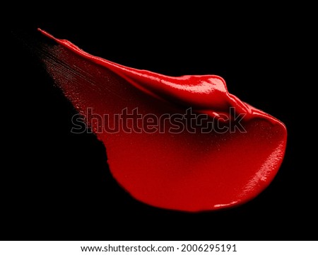 Red lipstick smear isolated on black background