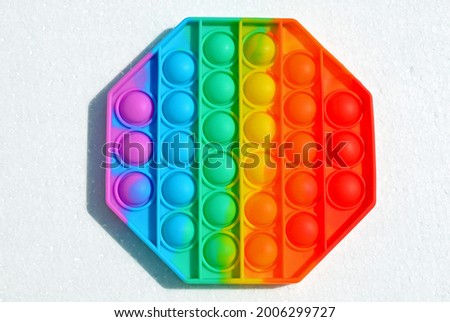 Finger push colorful polygon poppit game. Silicone Tie-dye Push pop Bubble isolated on white background Royalty-Free Stock Photo #2006299727