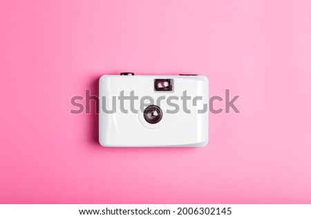 Film camera on a color minimal background. Photography, lifestyle concept