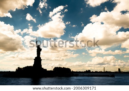 Statue of Liberty with a dramatic blue sky